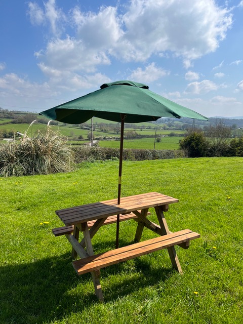 Picnic table with parasol in the countryside